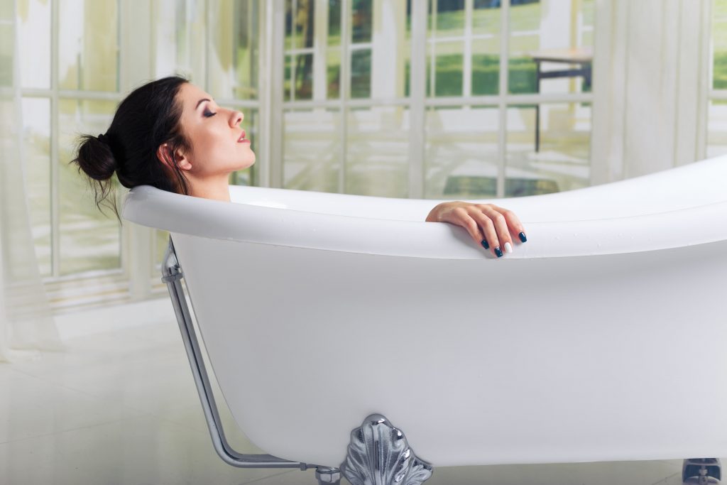 Brunette woman relaxing in aromatherapy bath to relieve stress