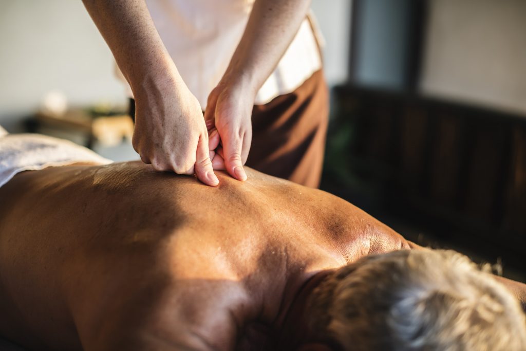 Masseuse giving a man an aromatherapy massage